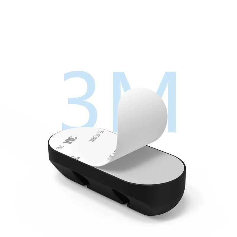 Set organizatoare cabluri din silicon negru aplicate pe suprafață de sticlă, vedere laterală și față