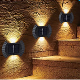 Set 4 Aplice solare LED Bidirectionale pentru perete Vivimall, in forma de funda, 8 LED-uri, material ABS si PC, lumina puternica, IP65, 10 x 7.5 cm, baterie 1.2 V, 300 mAh, autonomie 8-10 ore, alb cald - vivimall.ro