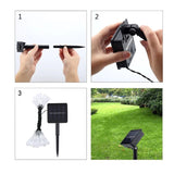 Instalație solară decorativă prinsă pe gard exterior, 28 LED-uri picătură de apă, fir negru, alb cald