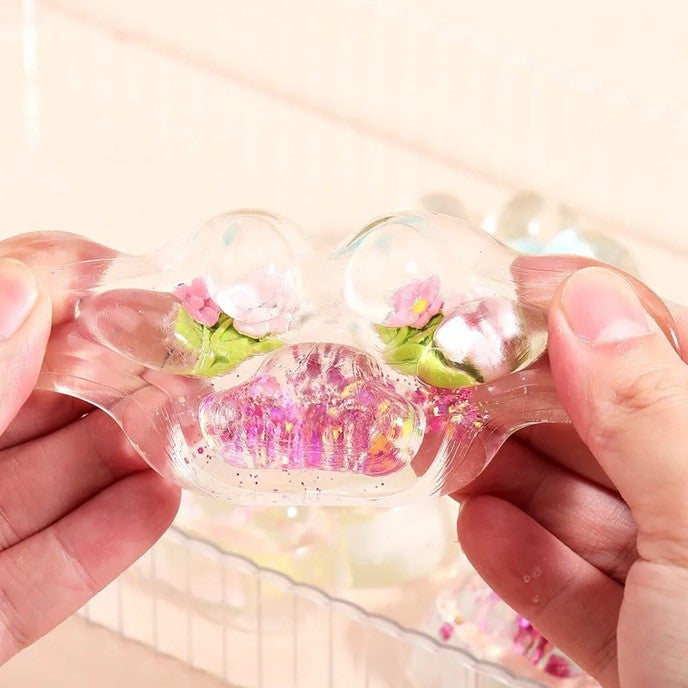 Jucarie Antistres Squishy, Flippy, Labuta de Pisica Pufoasa, cu Revenire Lenta, 7 x 6.5 cm, Model Flori 1, Transparent - vivimall.ro